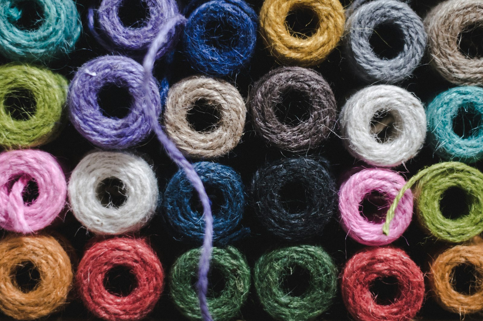 Spun and polyester fancy dyed yarn spools in assorted colours